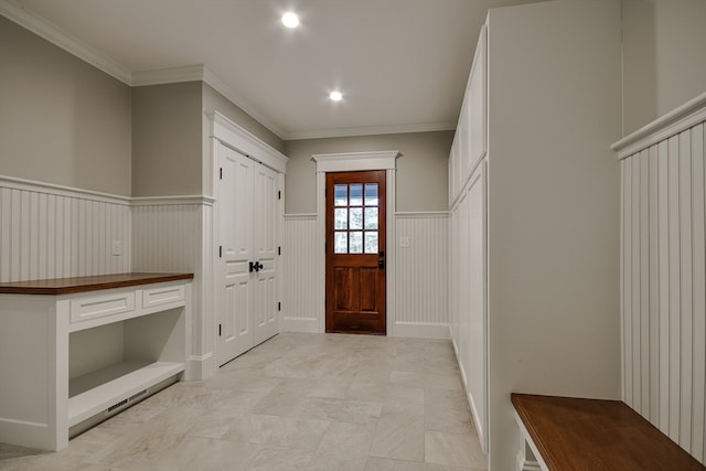 mudroom featuring crown molding and light tile floors