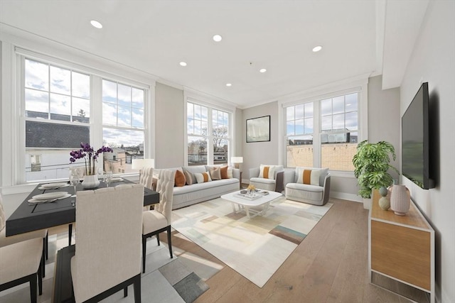 living room with recessed lighting, crown molding, baseboards, and wood finished floors