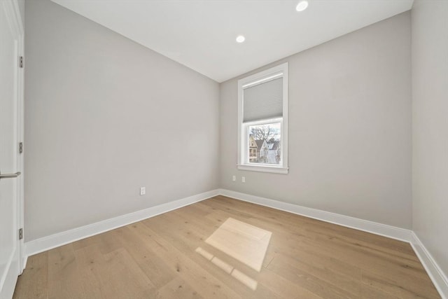 unfurnished room featuring recessed lighting, baseboards, and wood finished floors