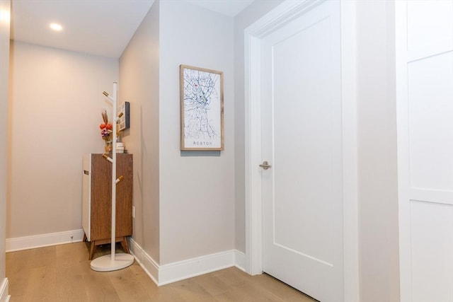 hall with recessed lighting, baseboards, and light wood-type flooring