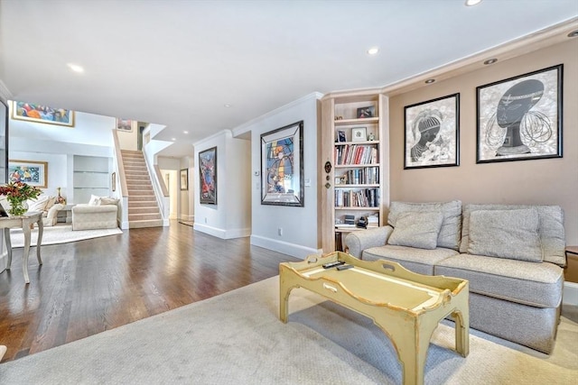 living area featuring baseboards, built in features, stairway, wood finished floors, and recessed lighting