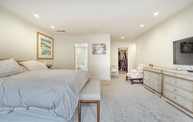 bedroom featuring a walk in closet, crown molding, recessed lighting, light carpet, and baseboards