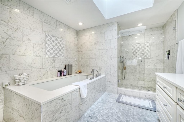 bathroom featuring recessed lighting, vanity, tile walls, a bath, and a stall shower