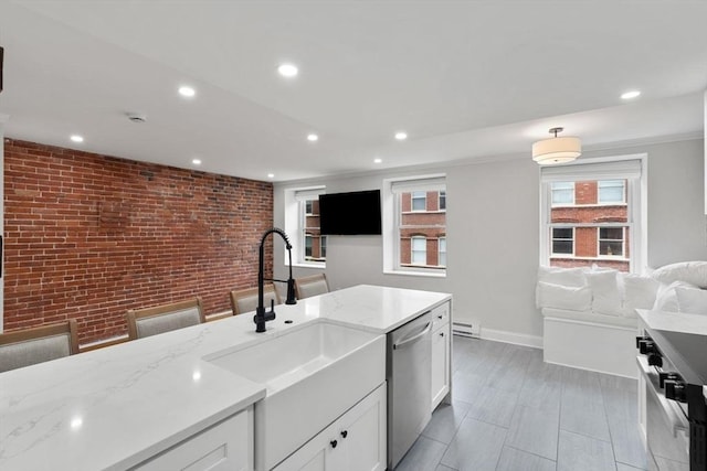 117 Fulton St Unit 4, Boston, MA 02109 - kitchen featuring stainless steel appliances, white cabinetry, light stone countertops, recessed lighting, and a baseboard radiator