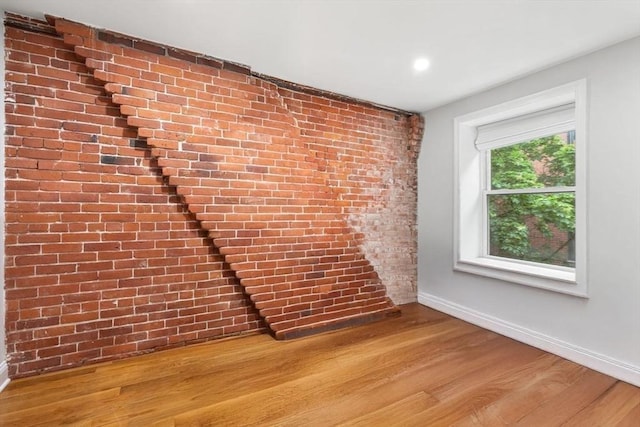 117 Fulton St Unit 4, Boston, MA 02109 - spare room with wood finished floors, recessed lighting, and brick wall