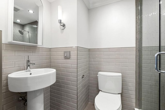 117 Fulton St Unit 4, Boston, MA 02109 - bathroom with tile walls, a shower stall, a wainscoted wall, ornamental molding, and recessed lighting