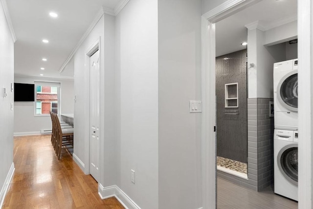 117 Fulton St Unit 4, Boston, MA 02109 - corridor featuring stacked washer / dryer, crown molding, light wood-style floors, recessed lighting, and a baseboard heating unit