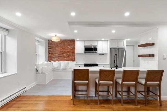 117 Fulton St Unit 4, Boston, MA 02109 - kitchen featuring appliances with stainless steel finishes, baseboard heating, backsplash, white cabinetry, and open shelves