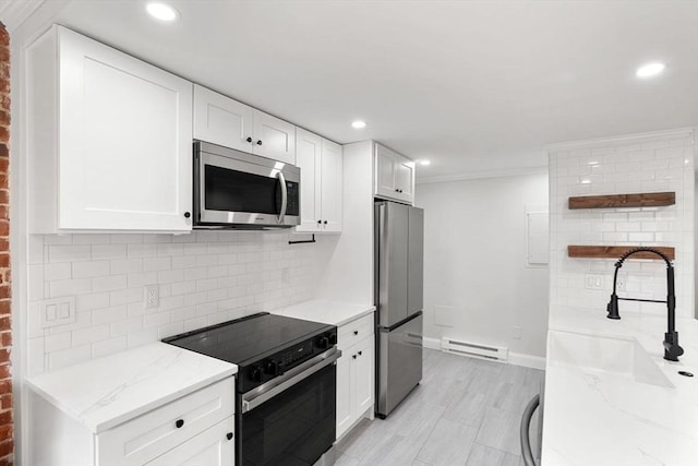 117 Fulton St Unit 4, Boston, MA 02109 - kitchen with appliances with stainless steel finishes, open shelves, a baseboard heating unit, light stone counters, and white cabinets
