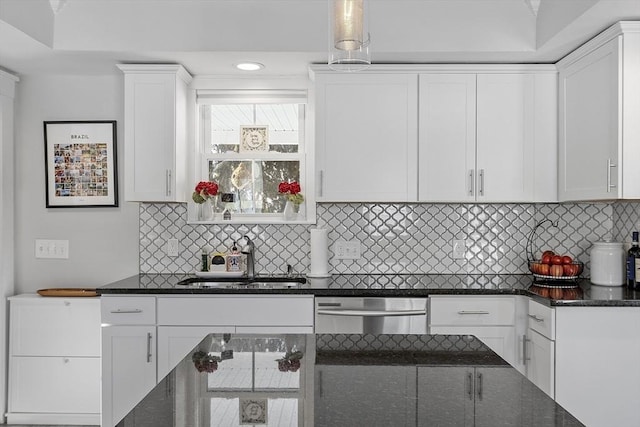 kitchen featuring dishwasher, white cabinetry, backsplash, and sink