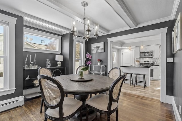 dining area with baseboard heating, an inviting chandelier, beam ceiling, ornamental molding, and wood-type flooring