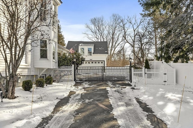 snow covered patio featuring a garage