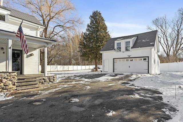 view of snowy exterior with a garage