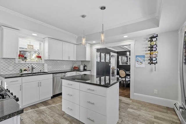 kitchen with a center island, dishwasher, white cabinetry, and sink