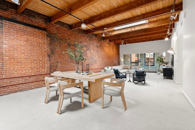 dining area featuring brick wall, carpet flooring, a skylight, and beamed ceiling