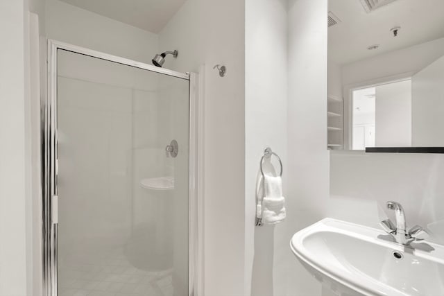 bathroom with an enclosed shower and sink