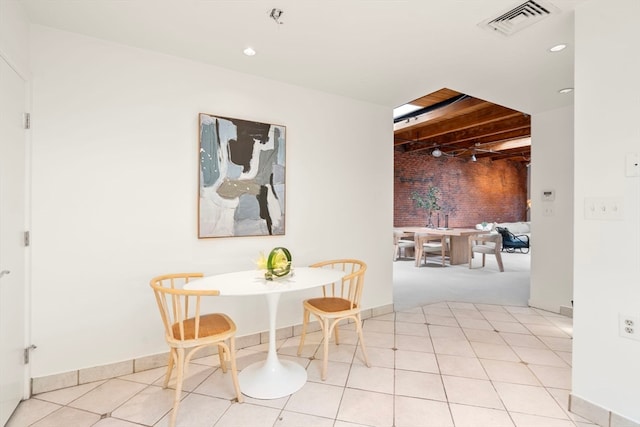 tiled dining area with beamed ceiling