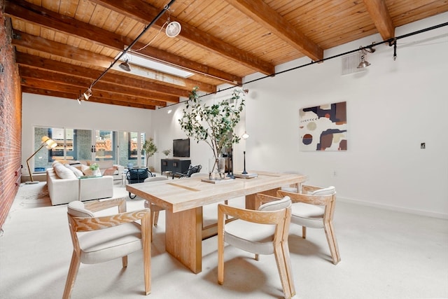 carpeted dining area featuring wood ceiling and beam ceiling