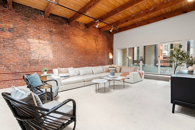 living room featuring brick wall, beamed ceiling, a towering ceiling, and wooden ceiling