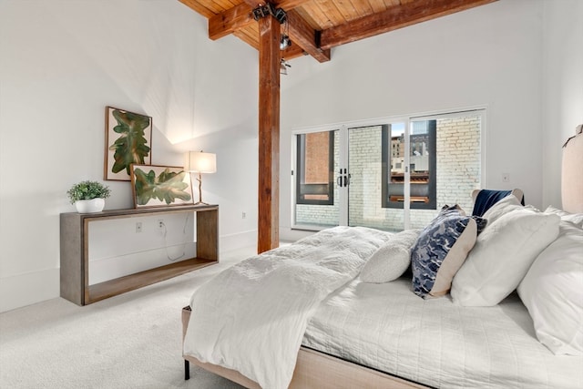 carpeted bedroom with french doors, beamed ceiling, high vaulted ceiling, and wooden ceiling