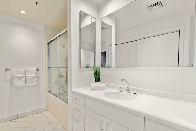 bathroom featuring bath / shower combo with glass door, tile patterned floors, and vanity