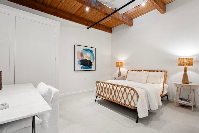 bedroom featuring beamed ceiling and wooden ceiling