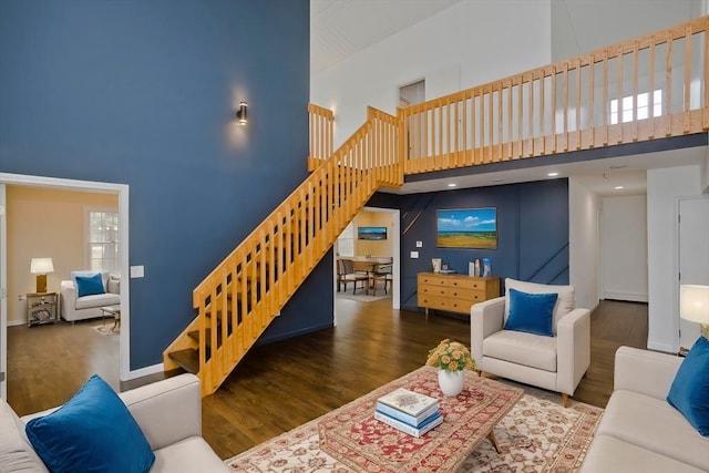 16 Poole Rd, Belchertown, MA 01007 - living area featuring baseboards, stairway, a high ceiling, and wood finished floors