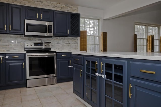 16 Poole Rd, Belchertown, MA 01007 - kitchen featuring backsplash, light countertops, blue cabinets, and stainless steel appliances