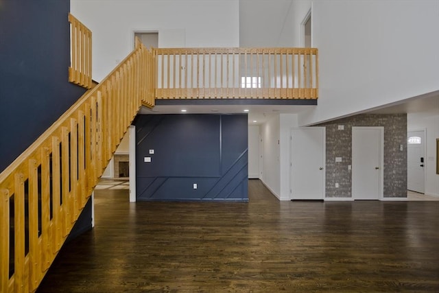 16 Poole Rd, Belchertown, MA 01007 - unfurnished living room with wood finished floors, a towering ceiling, and stairway