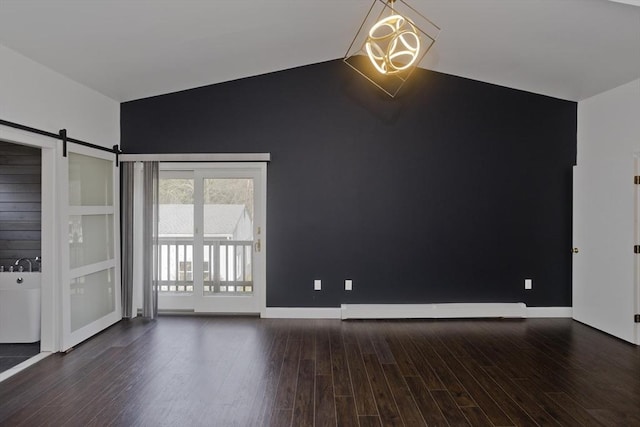 16 Poole Rd, Belchertown, MA 01007 - empty room featuring a barn door, baseboards, vaulted ceiling, and wood finished floors