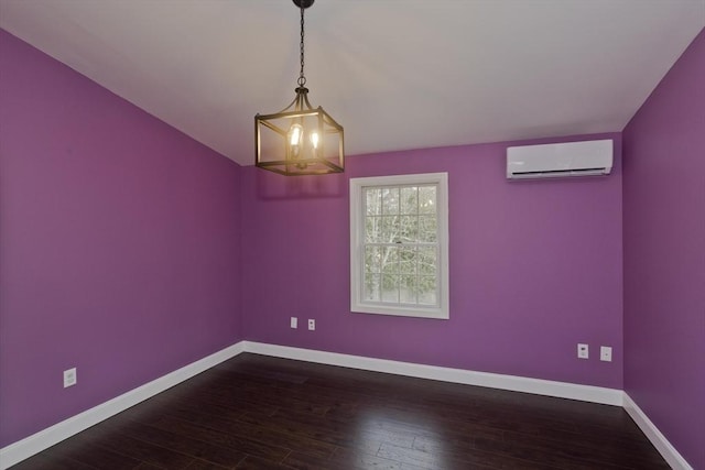16 Poole Rd, Belchertown, MA 01007 - spare room featuring baseboards, an inviting chandelier, hardwood / wood-style floors, and a wall mounted air conditioner