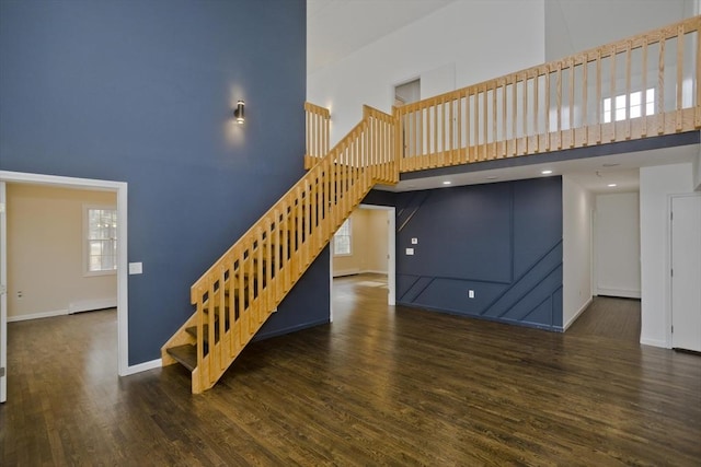 16 Poole Rd, Belchertown, MA 01007 - stairway with wood finished floors, a high ceiling, baseboards, and a healthy amount of sunlight