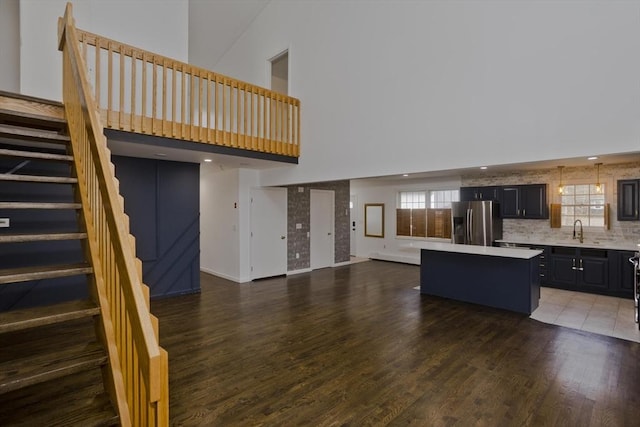 16 Poole Rd, Belchertown, MA 01007 - kitchen with a kitchen island, stainless steel refrigerator with ice dispenser, wood finished floors, light countertops, and a sink
