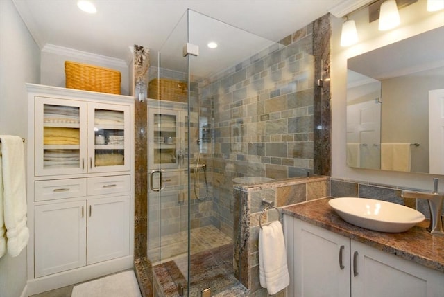 full bath featuring recessed lighting, a shower stall, vanity, and crown molding