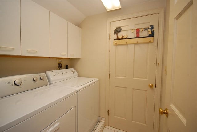 laundry room with cabinet space, light tile patterned floors, and washer and clothes dryer