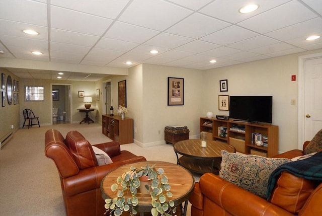 carpeted living area with baseboards, a paneled ceiling, and recessed lighting