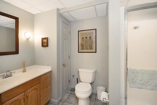 bathroom with toilet, tile patterned flooring, baseboards, and vanity