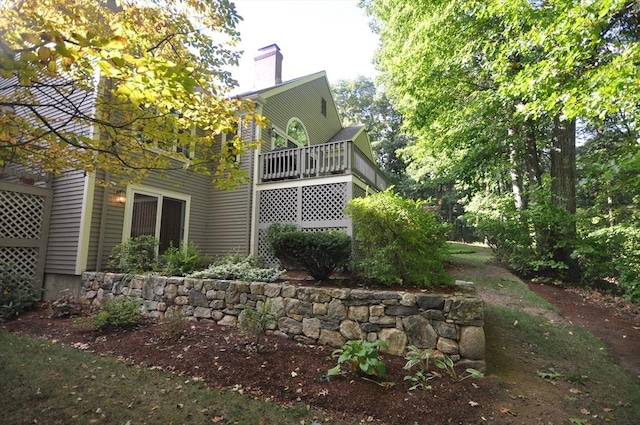 rear view of house with a deck and a chimney