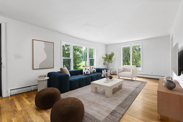 9 Margaret St, Burlington, MA 01803 - living area with a baseboard radiator, baseboard heating, plenty of natural light, and light wood finished floors