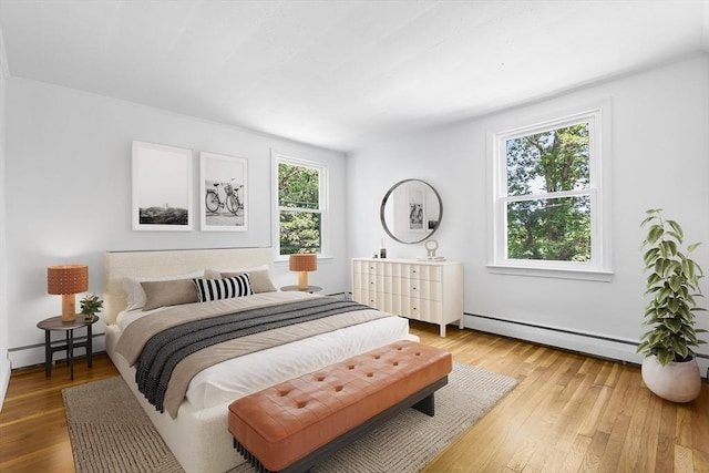 9 Margaret St, Burlington, MA 01803 - bedroom featuring a baseboard heating unit, baseboard heating, and light wood finished floors