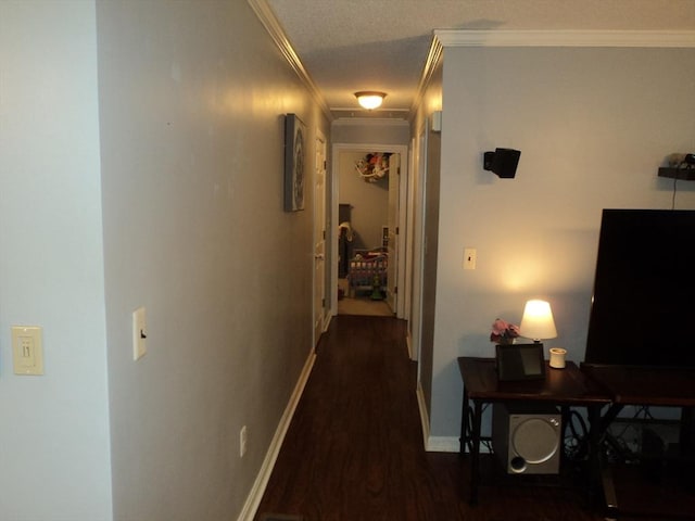 hall with crown molding, wood finished floors, and baseboards