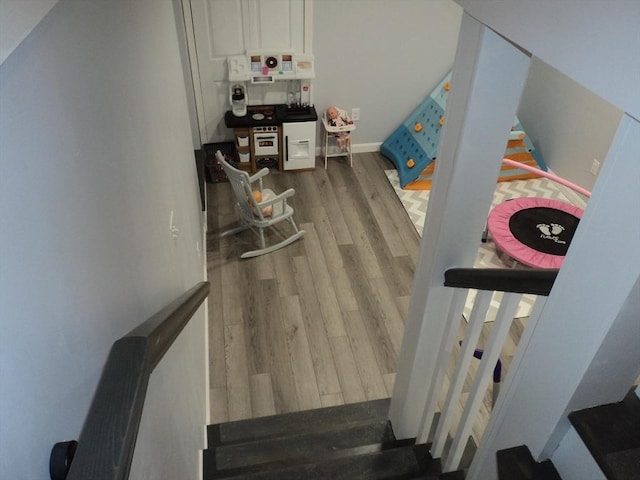 stairway with baseboards and wood finished floors