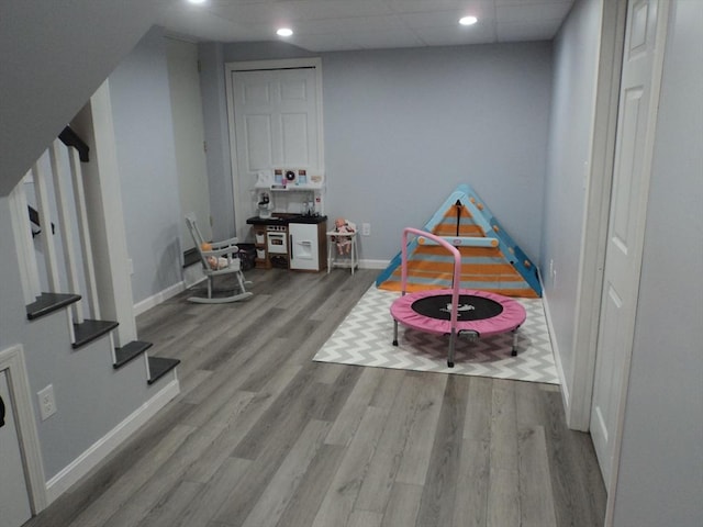 recreation room with wood finished floors and baseboards