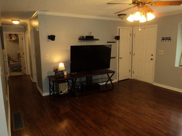 living area featuring crown molding, ceiling fan, visible vents, and wood finished floors