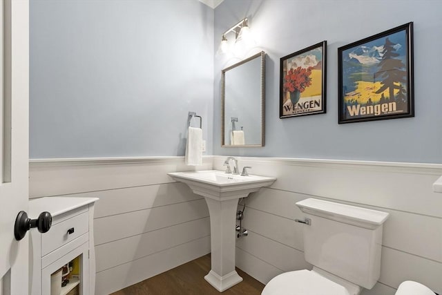 30 Southfield Ln Unit 30, Sherborn, MA 01770 - half bathroom with toilet, a wainscoted wall, and wood finished floors