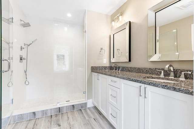 30 Southfield Ln Unit 30, Sherborn, MA 01770 - bathroom with a stall shower, double vanity, recessed lighting, and wood finished floors