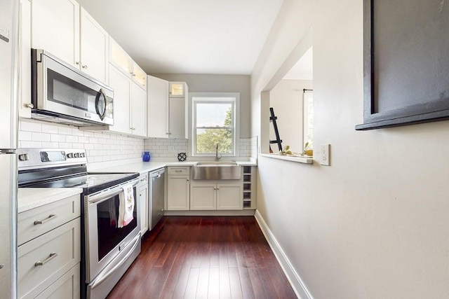 1834 Beacon St Unit 16, Brookline, MA 02445 - kitchen featuring stainless steel appliances, a sink, light countertops, and baseboards