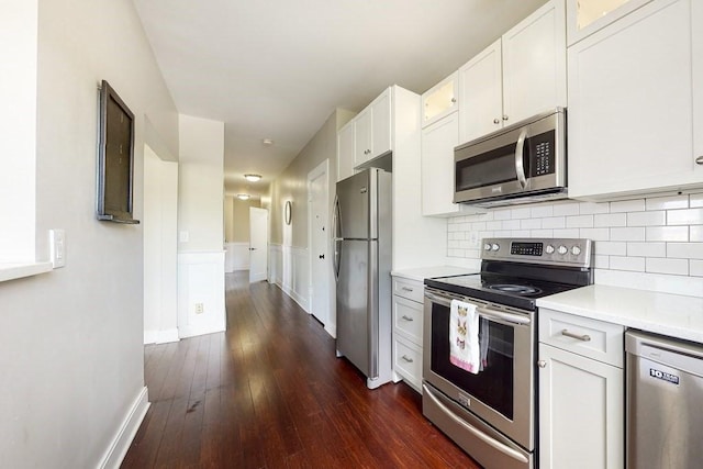 1834 Beacon St Unit 16, Brookline, MA 02445 - kitchen with stainless steel appliances, light countertops, dark wood-style floors, glass insert cabinets, and white cabinets