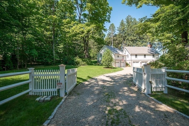 exterior space with a gated entry and gravel driveway
