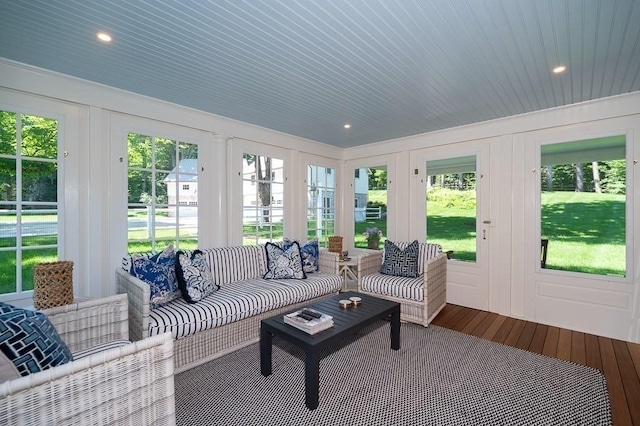sunroom with plenty of natural light, french doors, and outdoor lounge area
